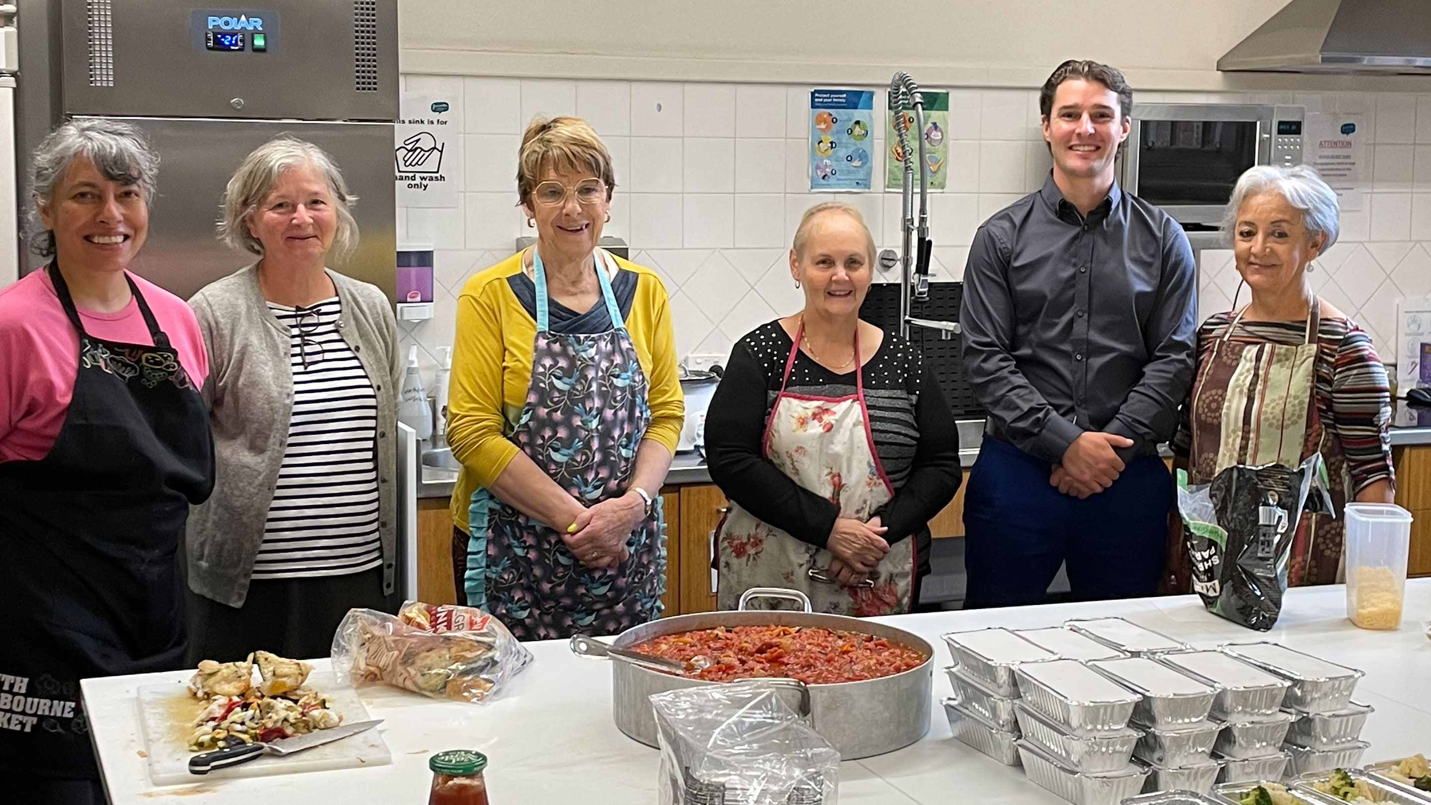 Image Yarraville’s Assistant Terminal Manager, David Barker, visits the kitchen team preparing meals for the Nourish Project at YCC.
