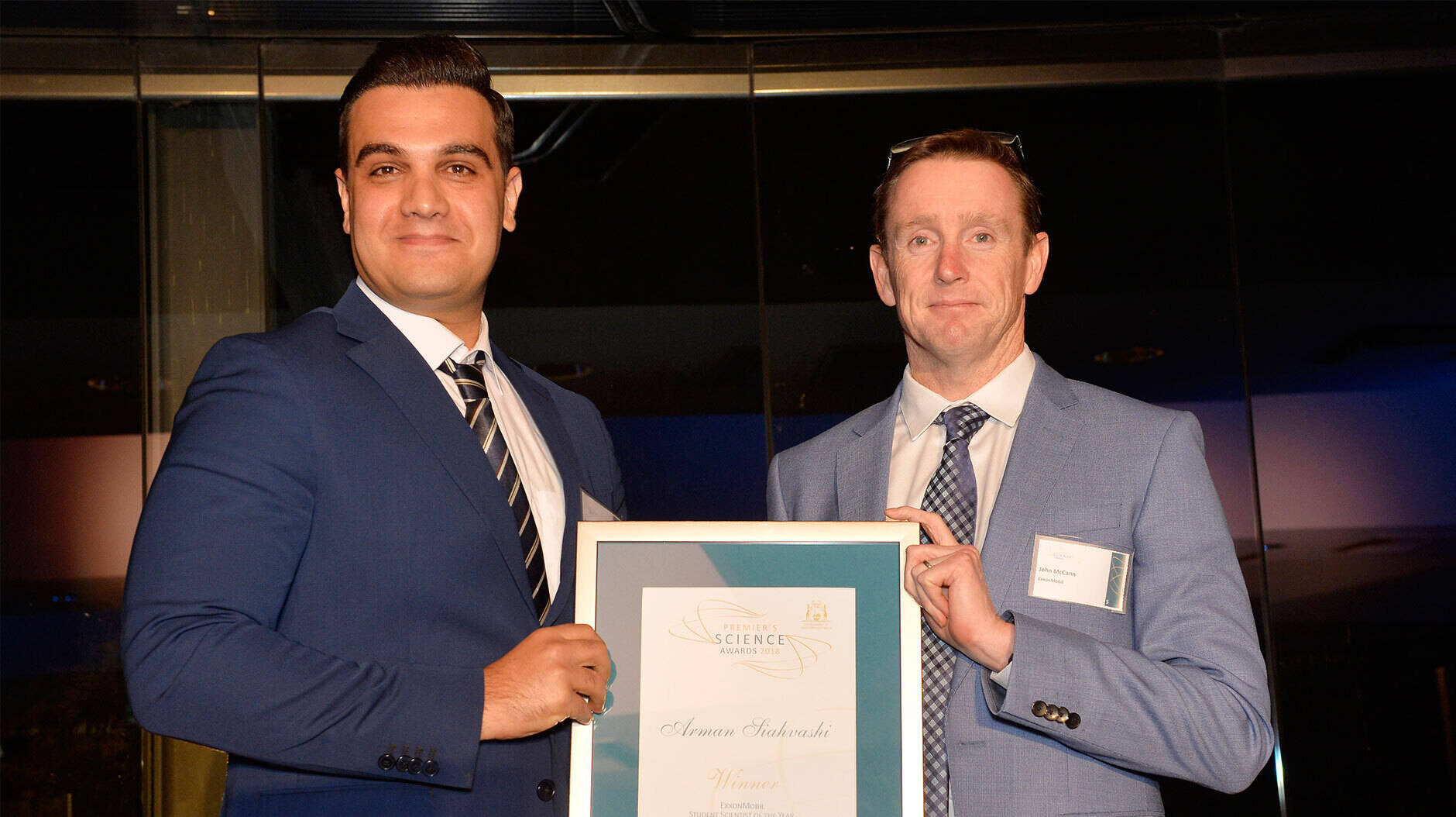 Image Photo — ExxonMobil's Joint Interest Manager, John McCann, presents the Student Scientist of the Year 2018 award to joint winner Arman Siahvashi.
