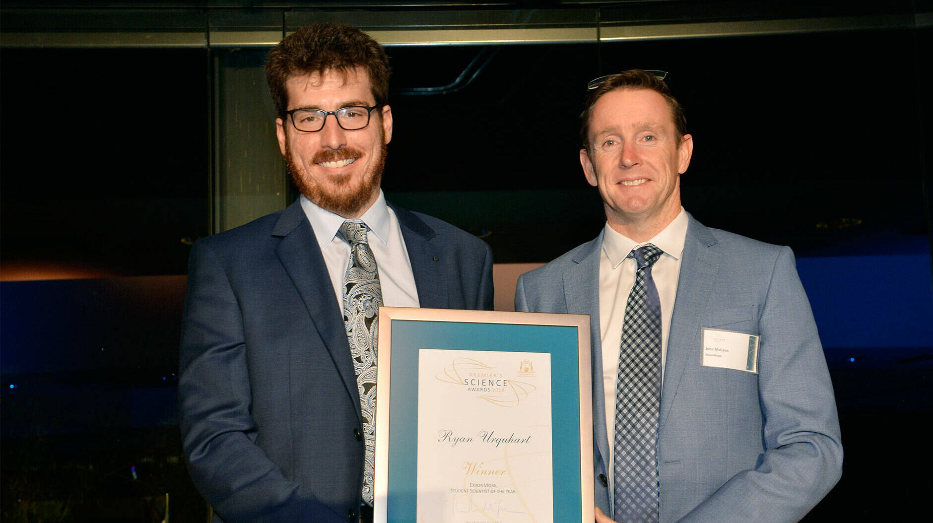 Image Photo  ExxonMobil's Joint Interest Manager, John McCann presents the Student Scientist of the Year 2018 award to joint winner Ryan Urquhart.