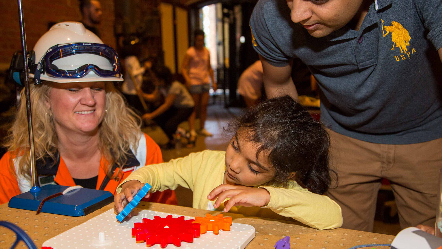 Image Photo — A young Scienceworks visitor demonstrates her puzzle skills to ExxonMobil’s Nikki Calcraft. “These activities have been designed to ignite curiosity in the next generation.” Photo by: Rod Start/Museums Victoria